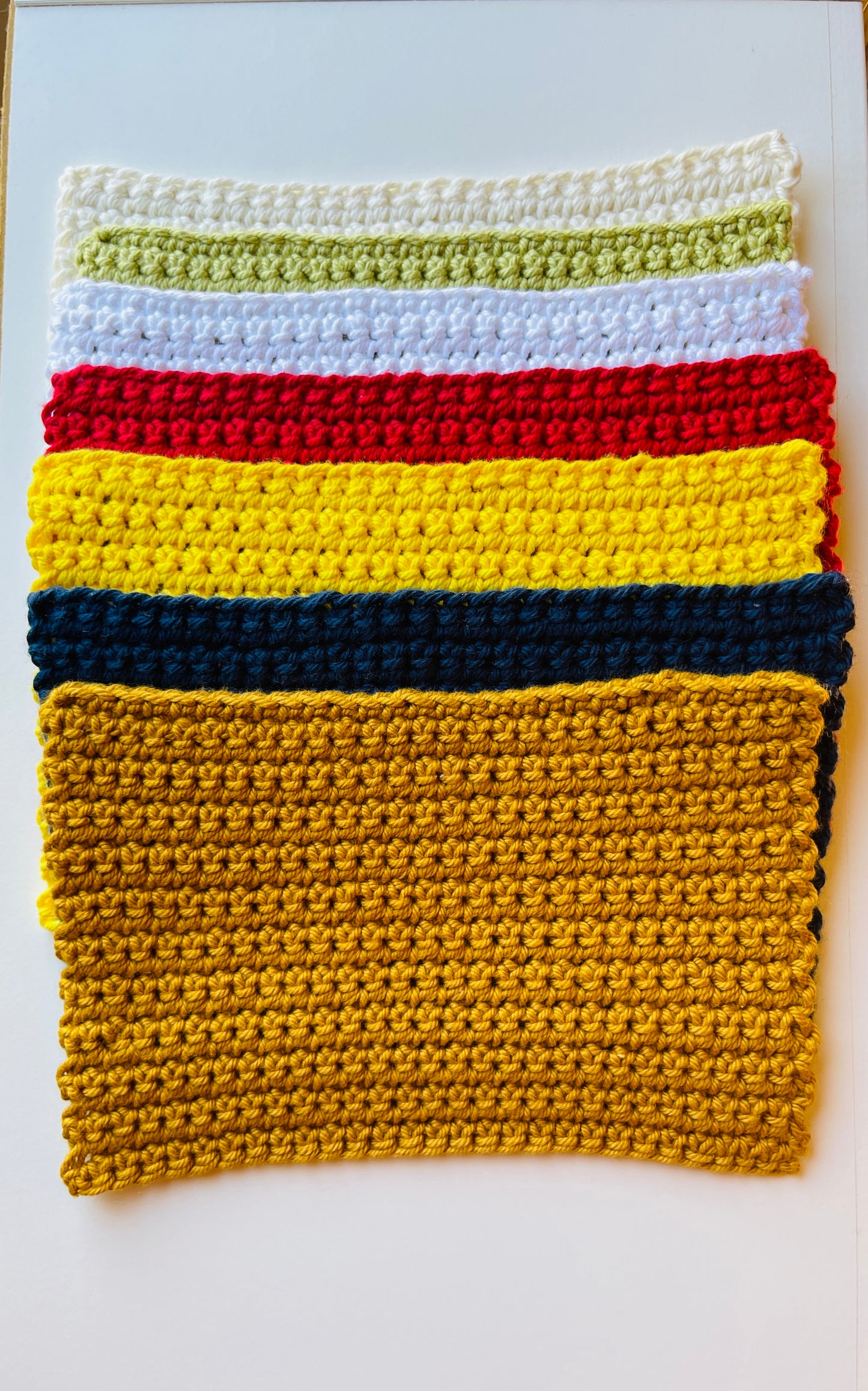 Wash cloths unfolded laying on a white surface