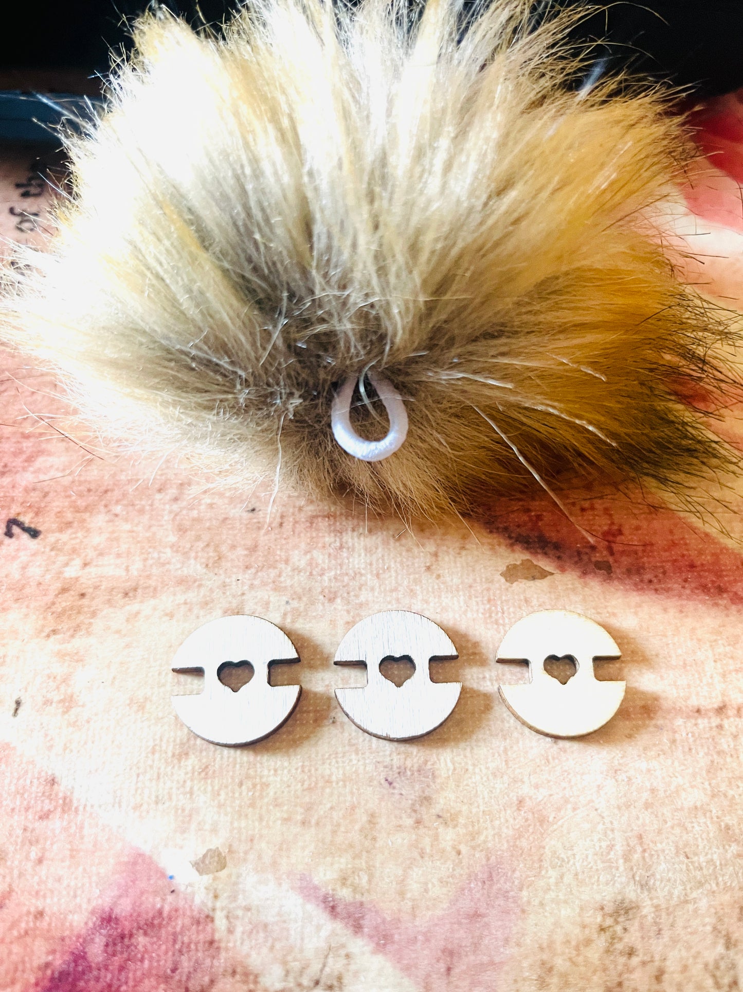 One Pom Pom three wood detachable wood holder on a texture surface