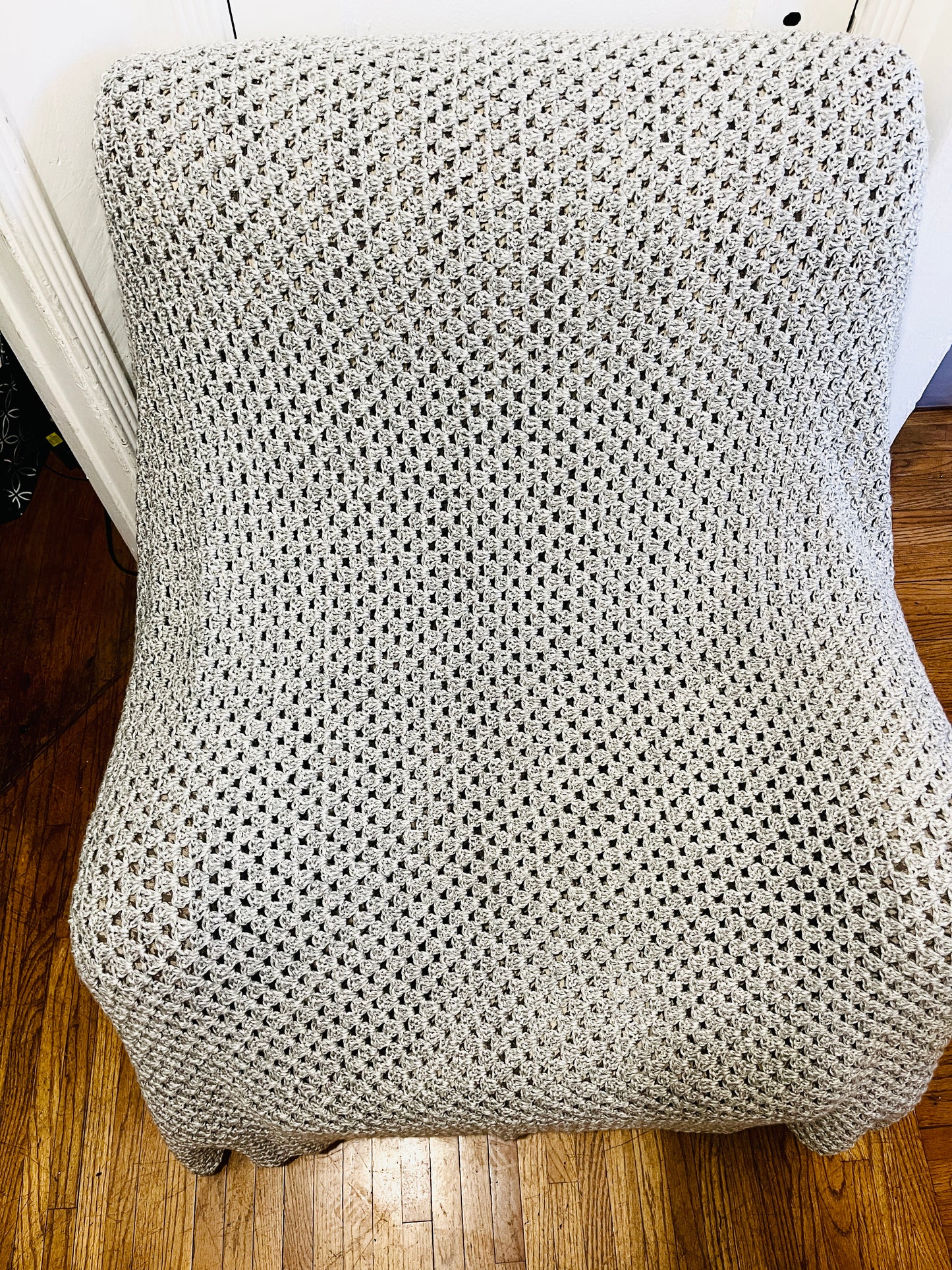 Handmade crochet afghan display on a chair